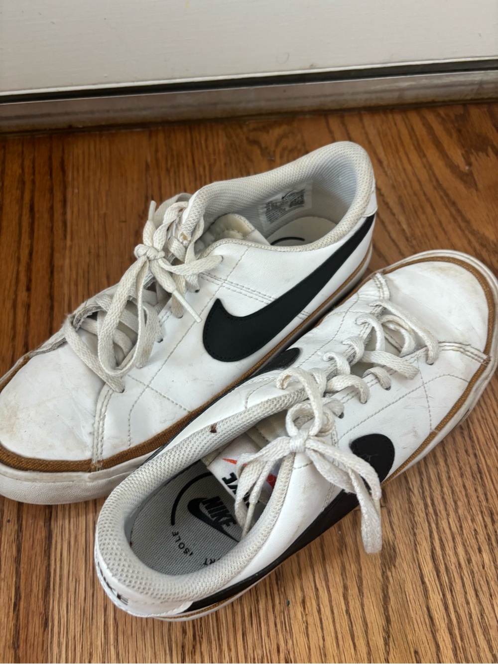 Nike Kids White Sneakers with Black Swoosh and Gum Trim